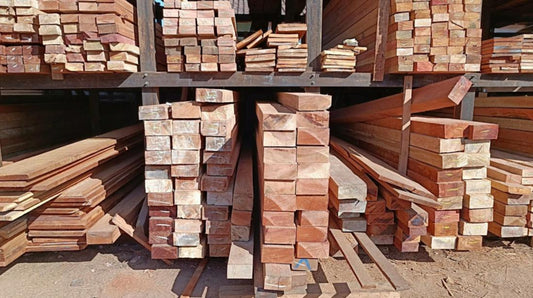 Stacks of lumber in a lumber yard that offer different options for wood garden edging.