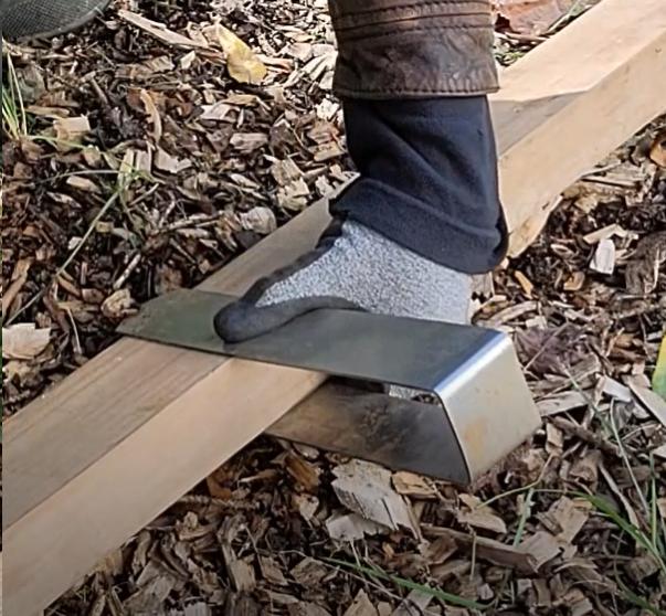 The correct way to grip a 2xEDGE Staple that's been placed over 2x4 lumber with a focus on where to place the thumb.