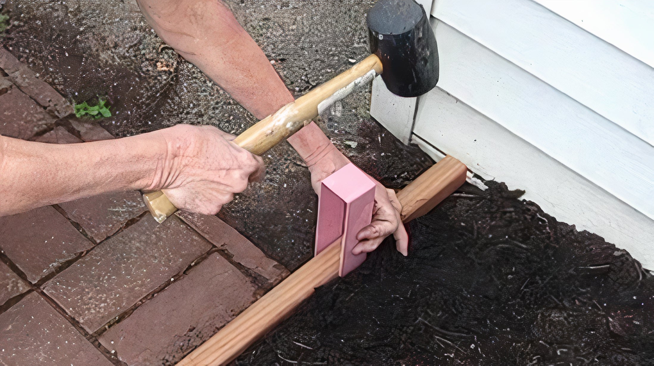 Someone installing 2x2 two-by lumber a Rose Pink 2xEDGE Staple with a 16 ounce rubber mallet.